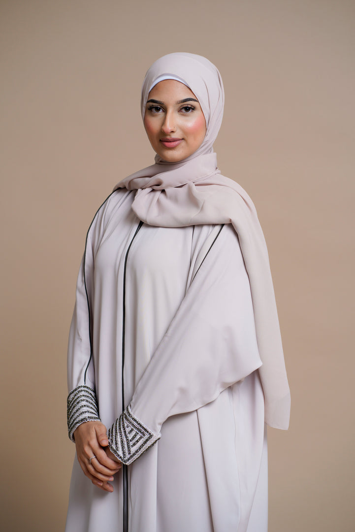 Embellished pearl gray abaya with handwork and olive piping.