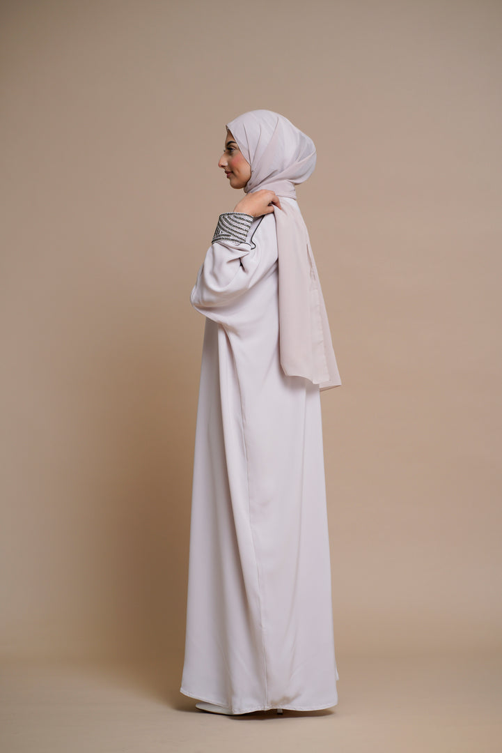 Embellished pearl gray abaya with handwork and olive piping.